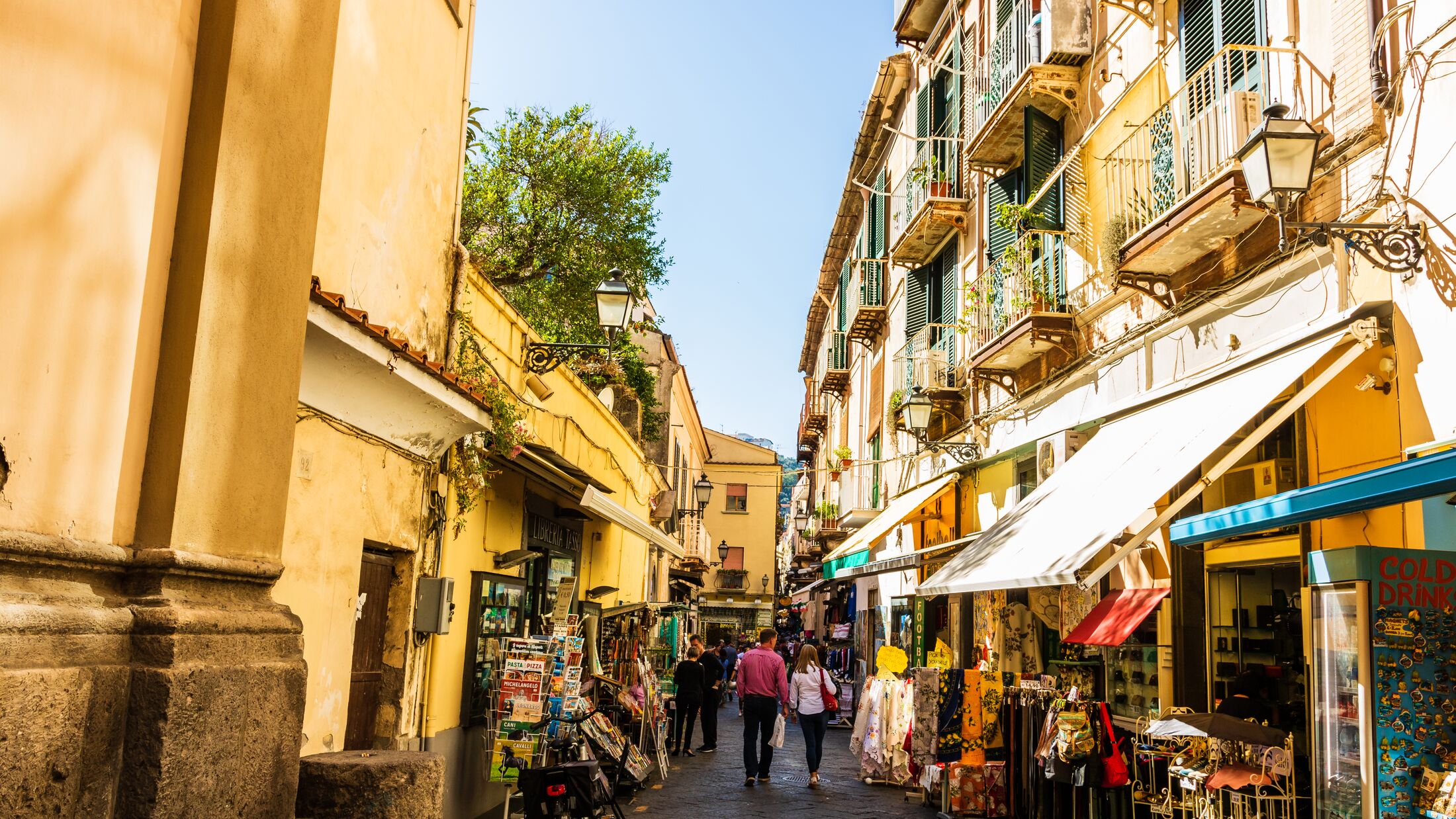 Couple walking on the narrow streets of Sorrento, Italy. Local shops in Sorrento.