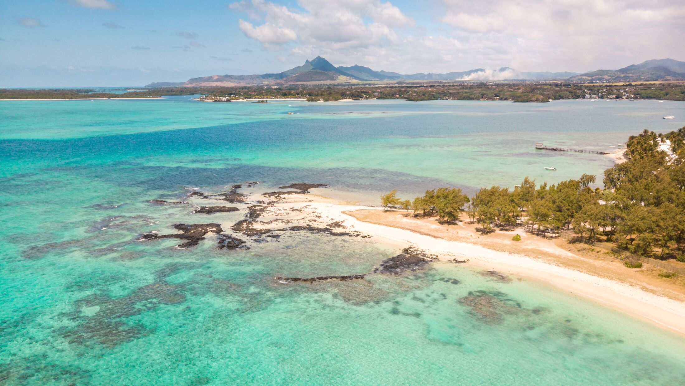 Aerial view of beautiful tropical beach with turquoise sea. Tropical vacation paradise destination of D'eau Douce and Ile aux Cerfs Mauritius