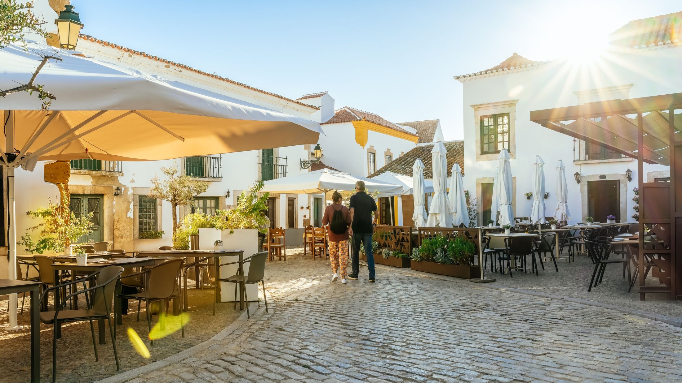 Faro, Algarve, Portugal - A tourist couple visiting Faro old town street.