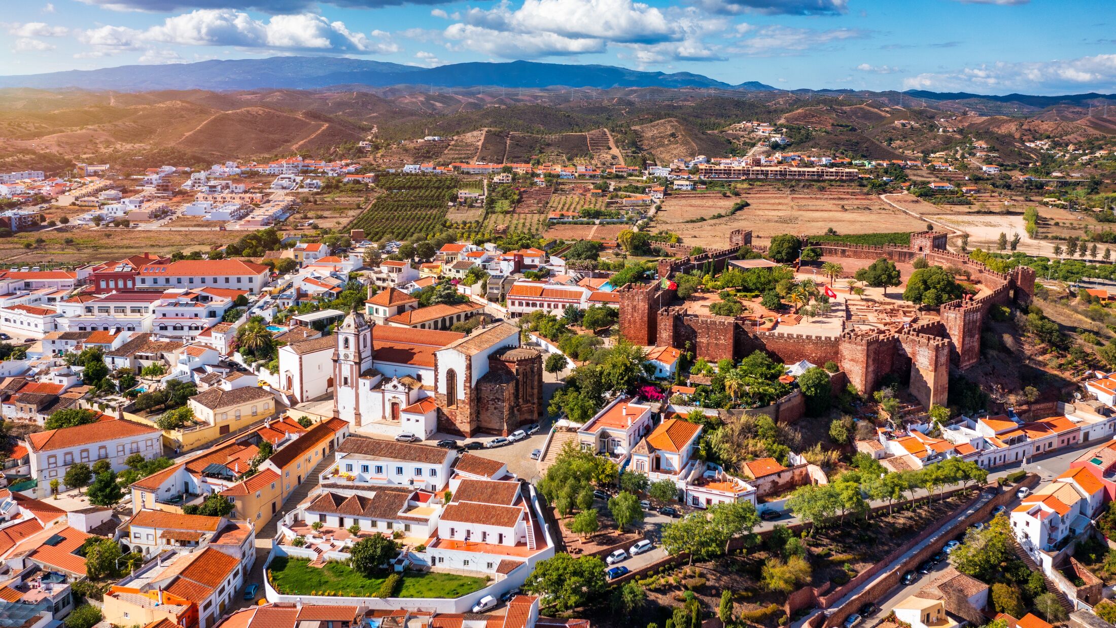 View of Silves town buildings with famous castle and cathedral, Algarve region, Portugal. Walls of medieval castle in Silves town, Algarve region, Portugal.