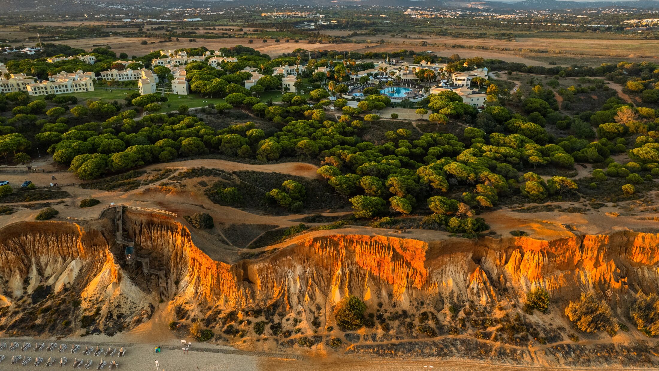 Praia da Falesia, Algarve beach in Albufeira, Portugal. Aerial drone view at sunset