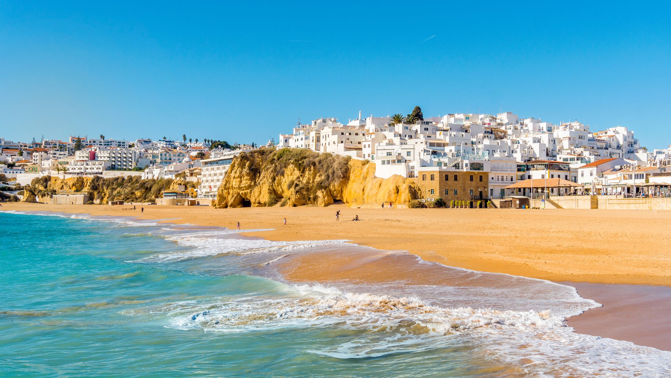 Wide sandy beach in white city of Albufeira, Algarve, Portugal