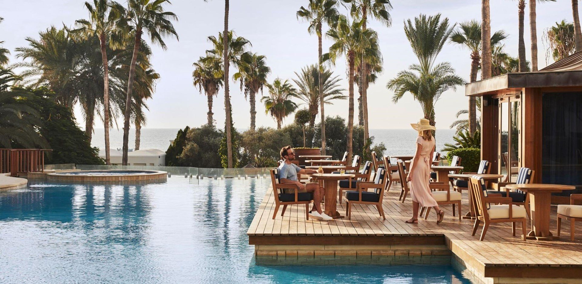 a group of palm trees next to a pool of water